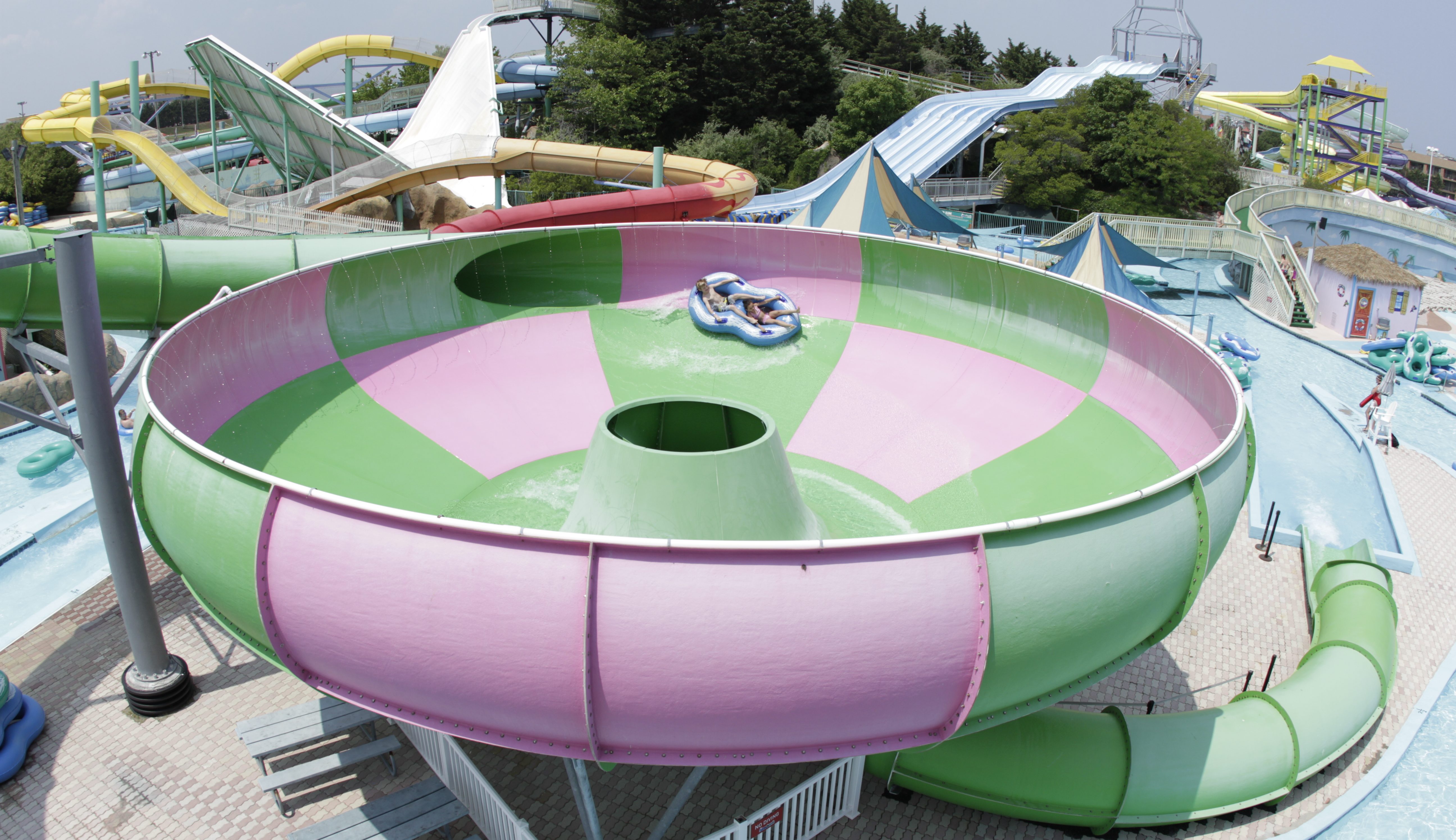 splash-mountain-eye-of-the-hurricane a pink and green hurricane shaped ride at a water park