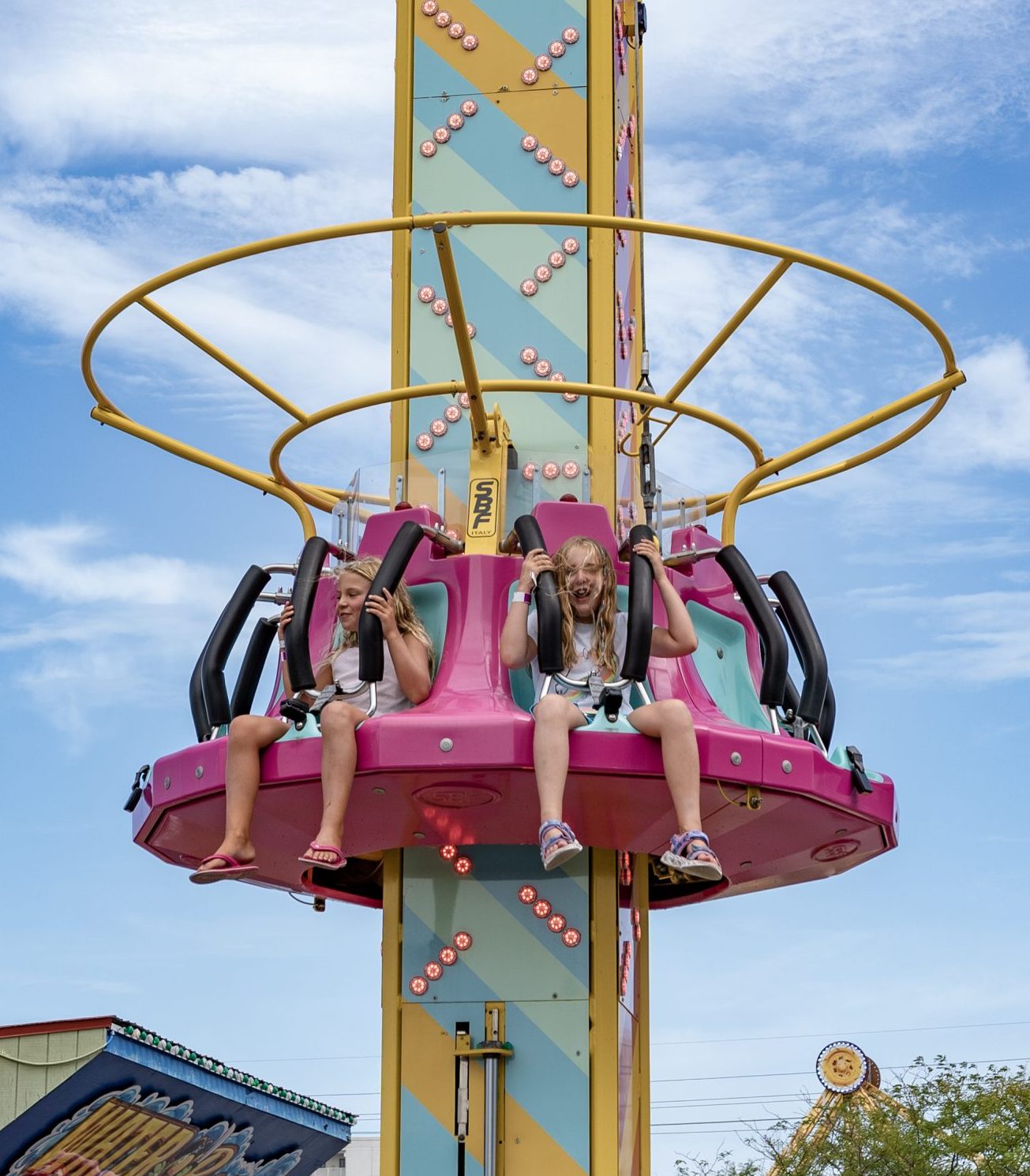 Jolly Roger Park Drop & Twist Ride Pink and yellow drop ride at Jolly Roger