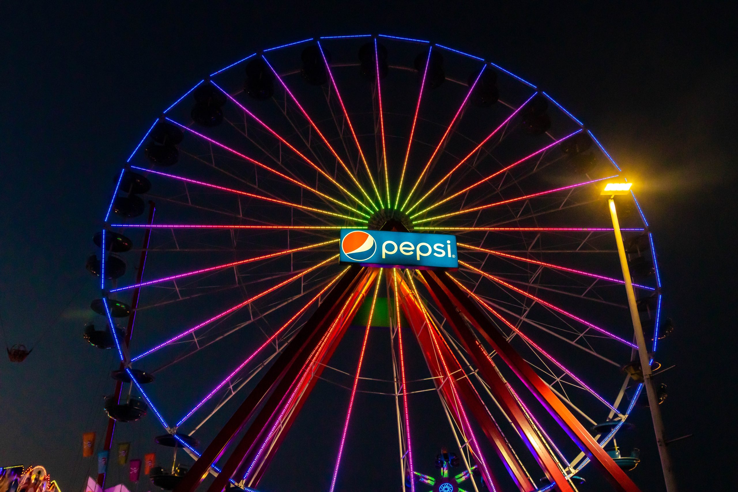 The Big Wheel Jolly Roger the Pier Giant Ferris Wheel with rainbow LED lights and a Pepsi Sign in the Middle